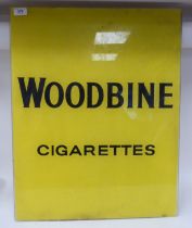 A vintage black on opaque yellow glass advertising sign, inscribed 'Woodbine Cigarettes'  25" x 20"