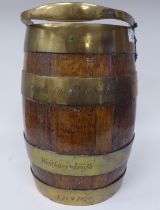 A late 19thC coopered oak and brass bound bucket with a swing handle  bears the engraved legend '