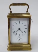 A late 19thC lacquered brass cased carriage timepiece with bevelled glass panels; the movement faced