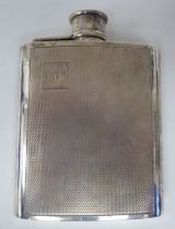 A silver hip flask of curved form with engine turned decoration and a rotating, hinged cap  WRA