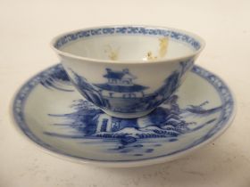 A Nanking Cargo porcelain tea bowl and saucer, traditionally decorated in blue and white  bearing