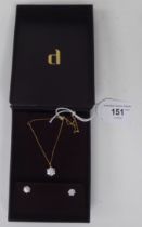 A suite of 18ct gold jewellery, viz. a pair of white stone set earrings and a pendant, on a fine