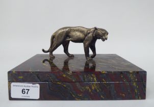 A Tiger Ironstone cigarette box of shallow form with a standing, textured gilded metal big cat,