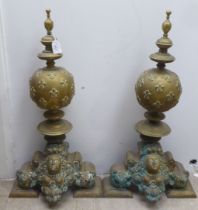 A pair of 19thC Continental brass andirons, each comprising an orb and finial, over a female