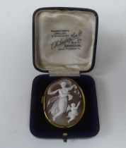 A Victorian yellow metal framed, oval, shell carved cameo brooch, featuring classical dancing