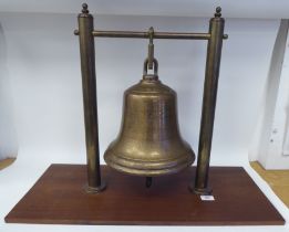 A cast bronze marine bell, inscribed 'A&M 1943' with a clapper  10"dia, suspended between a pair