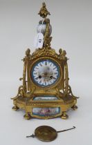A late 19thC Continental gilt metal cased mantel clock, set with painted porcelain panels; the 8 day