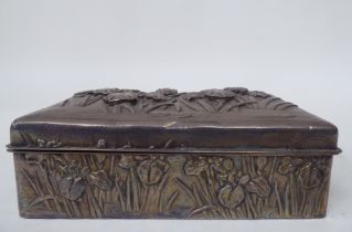 An early 20thC Chinese silver coloured metal clad, hardwood cigarette box, embossed in Sino-