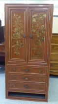 A modern painted Chinese cabinet with a pair of doors, enclosing eight drawers, over three long