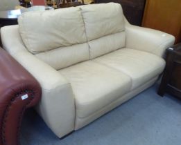 A modern two person cream coloured hide upholstered settee