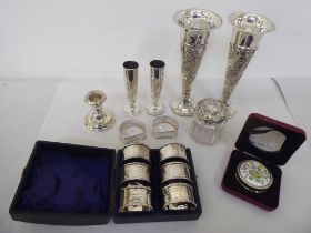 Silver collectable items: to include a set of six engine turned napkin rings; and a pair of loaded