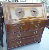 A modern Chinese fruitwood bureau with a fall flap, over two short/two long drawers, raised on block