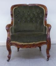 A mid 19thC walnut framed salon chair with a button upholstered green fabric back, raised on