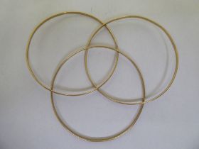 Three yellow metal bangles  stamped 375