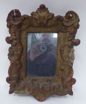 A 19thC mirror, the plate set in a wide, gilt gesso frame, decorated with shell and scrolled
