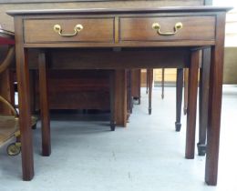 A Georgian style mahogany serving table, the pair of inline drawers with brass bail handles,