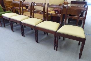 A set of five William IV mahogany framed, twin bar back dining chairs, the later fabric