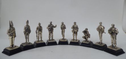 A series of nine similar white metal models, British uniformed soldiers, on plinths  approx. 4.25"h