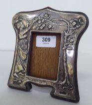 An early 20thC Art Nouveau silver mounted photograph frame, embossed with a woman picking apples