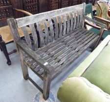 A slatted weathered teak garden bench  59"w