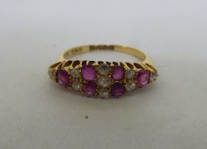 An 18ct gold, diamond and ruby set cluster ring