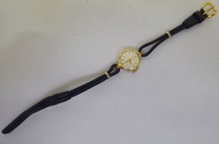 A lady's Tudor 18ct gold cased wristwatch, faced by a baton dial, on a black hide strap