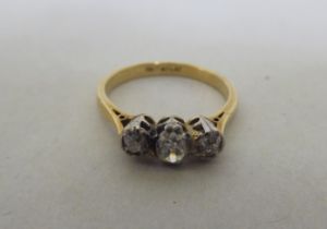 An 18ct gold and platinum three stone diamond ring