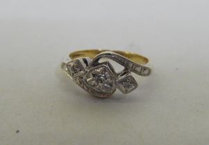 An 18ct gold and platinum free-flowing, heart shaped and other diamond set ring