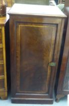 A late Victorian mahogany pedestal cupboard with a door, enclosing a door and two drawers, on a