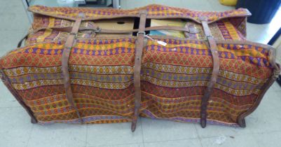 A Mafrash design multi-coloured camel bag with leather straps  17"h  40"w