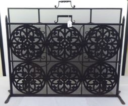 Two similar modern black painted wrought iron framed mesh panelled, freestanding spark guards  26"h