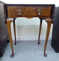 A 1930s Pembroke style walnut finished, butterfly top side table with a frieze drawer, raised on