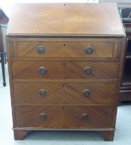 A 1930s mahogany finished bureau, the fall flap enclosing a fitted interior, over four long drawers,