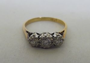 An 18ct gold and platinum three stone diamond ring