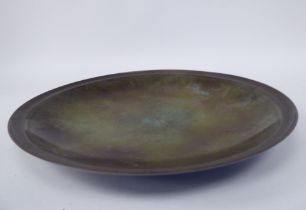 A Just Anderson part-patinated green and brown bronze, footed, shallow dish with a double tramline