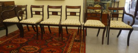 A set of six Regency reproduction brass inlaid mahogany dining chairs, the fabric covered drop-in