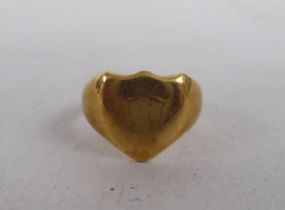 An 18ct gold, shield design signet ring