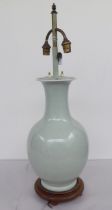 A mid 20thC Chinese celadon glazed porcelain table lamp with a twin branch, height adjustable