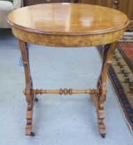 A late Victorian walnut and mahogany occasional table with a shallow frieze drawer, raised on