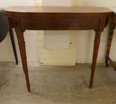 An early 19thC rosewood demi-lune card table, the foldover top raised on ring turned, tapered