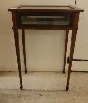 An Edwardian mahogany fully glazed display table, the box top enclosed by a hinged lid, raised on