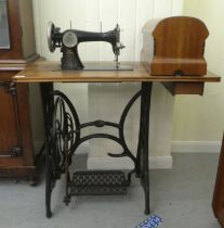 A vintage Simanco sewing machine, set in a cast iron treadle frame  29"h  35"w