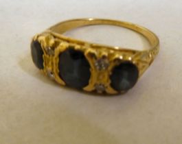 A yellow metal sapphire and diamond set ring  stamped 18k