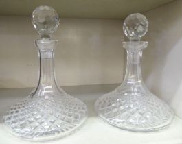 A pair of diamond cut crystal ships' decanters and stoppers
