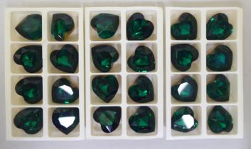 A set of twenty-four Swarovski emerald coloured and gilded crystal heart shaped stones  boxed