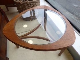 A 1970s teak framed coffee table with a glass insert, raised on a bentwood underframe  17"h  30"dia