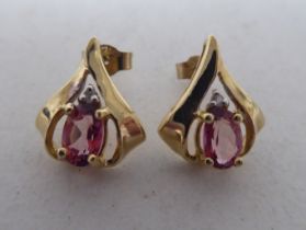 A pair of yellow metal earrings, set with pink and white stones