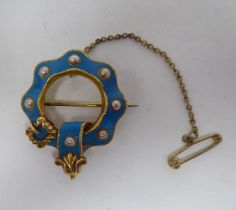 A yellow metal, pearl and blue enamel brooch