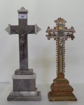 Two freestanding crucifixes, one a cast metal example, decorated with floral patterns  16.5"h; and a