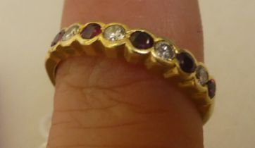 An 18ct gold ring, set with alternating diamonds and rubies